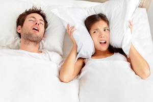 Man snoring in bed due to sleep apnea